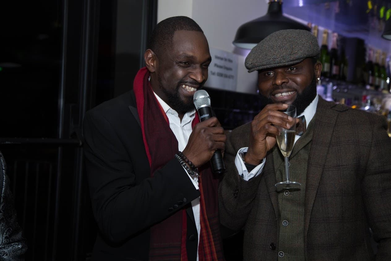MoHC member hosting at a consortium social event with microphone